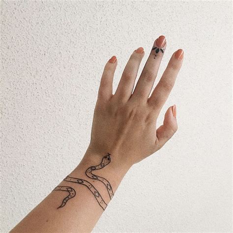 snake on wrist tattoo